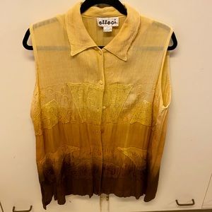 Sleeveless multi-coloured shirt.